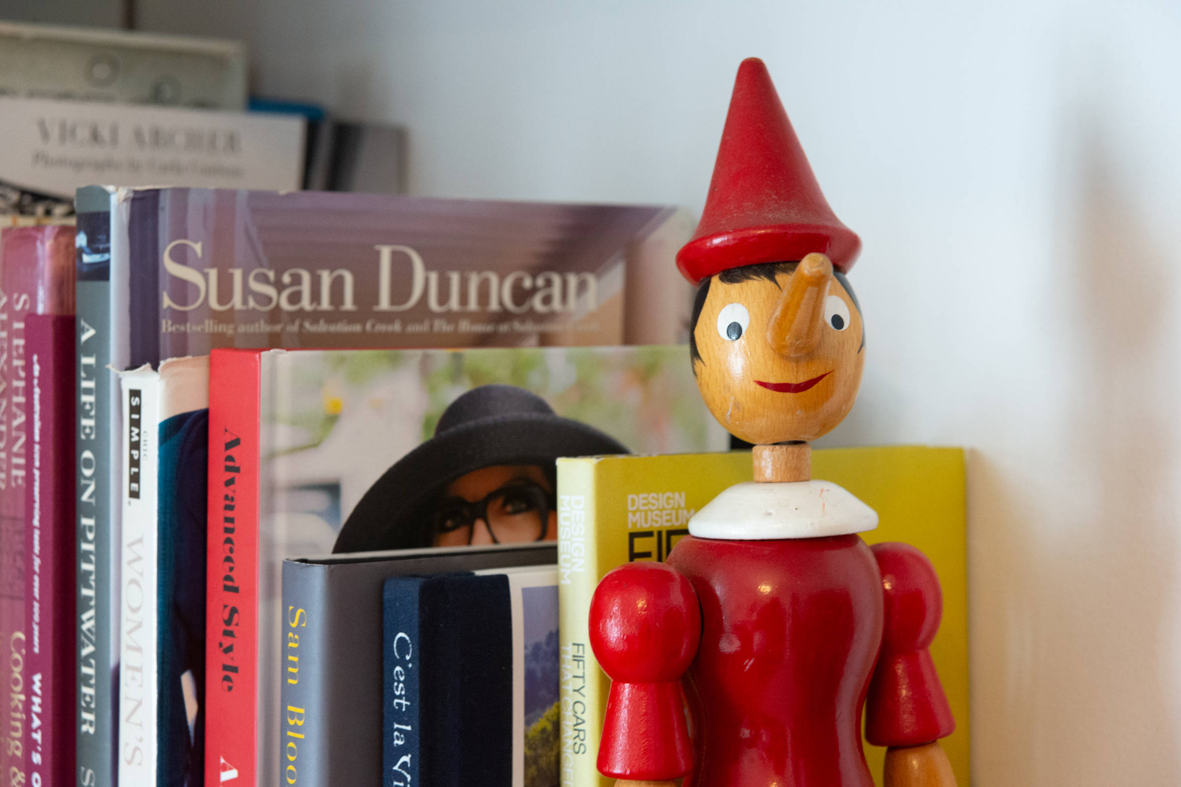Bookshelf with Pinocchio doll. Photo: Oliver Berlin.
