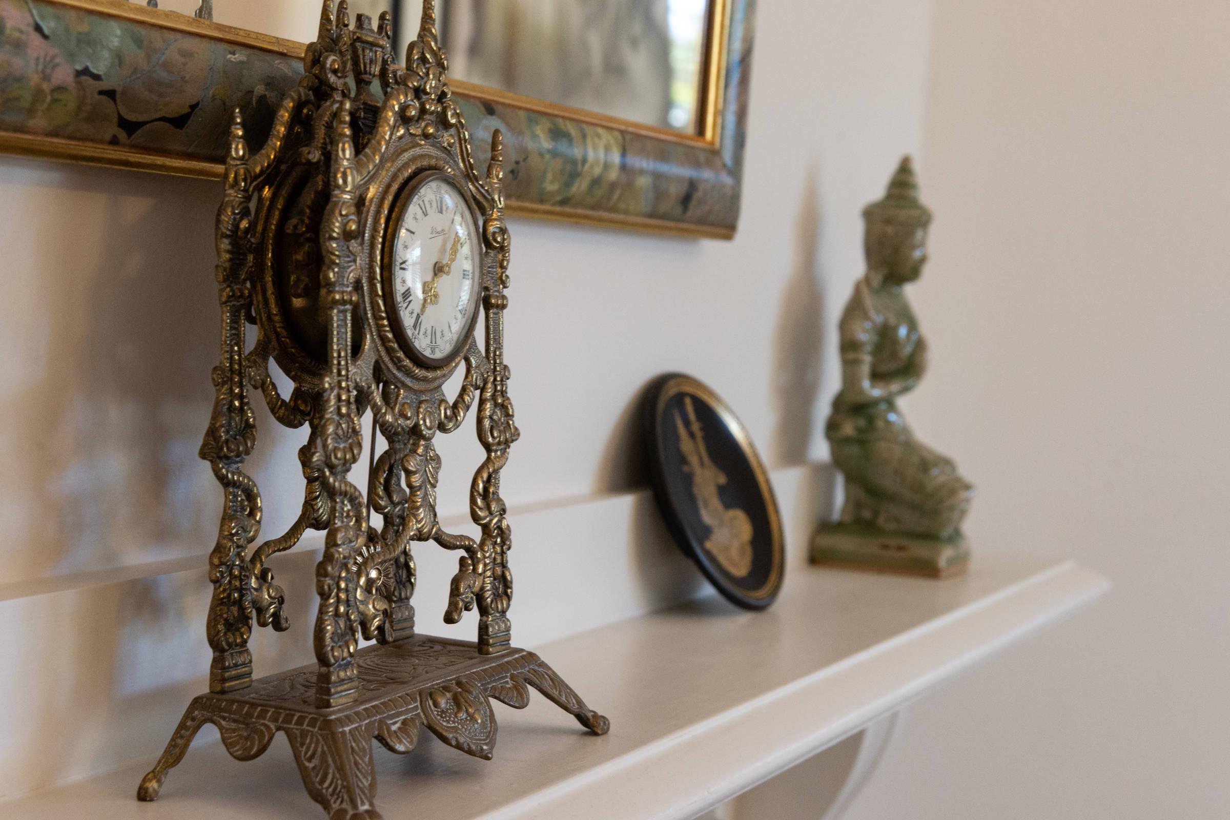 Detail of shelf with clock and statue. Photo: Oliver Berlin.
