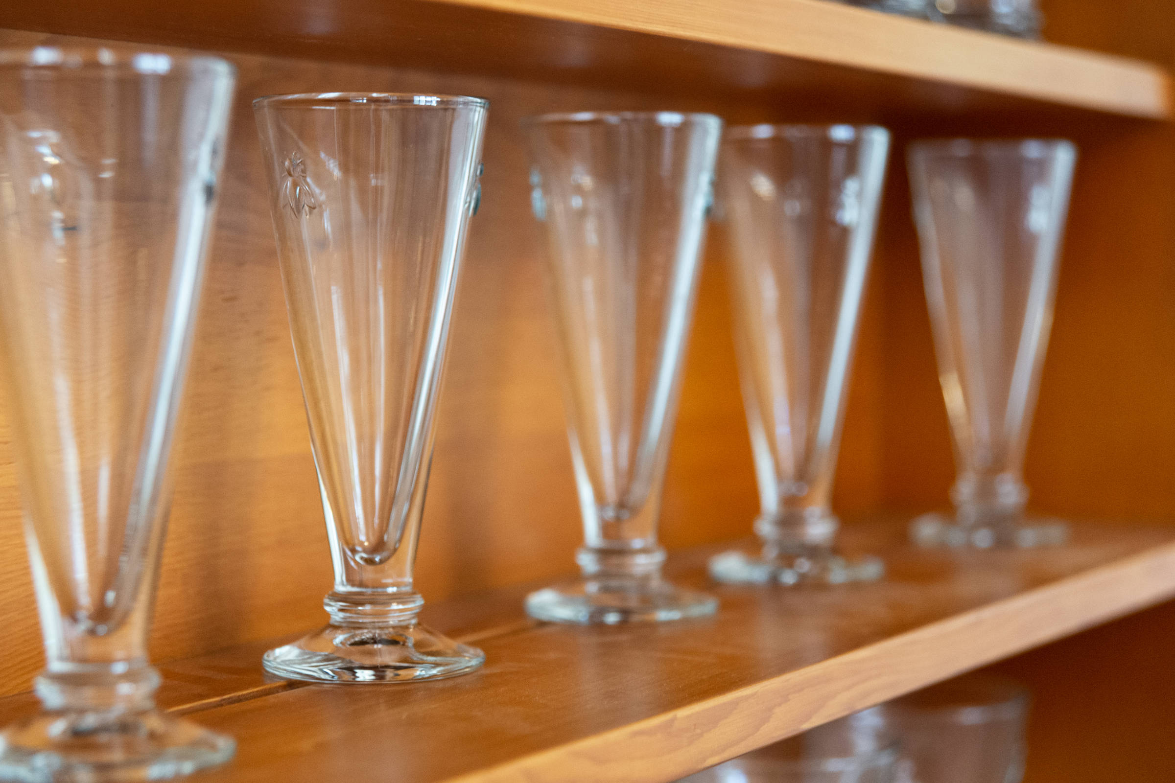 Close up glasses on shelf. Photo: Oliver Berlin.