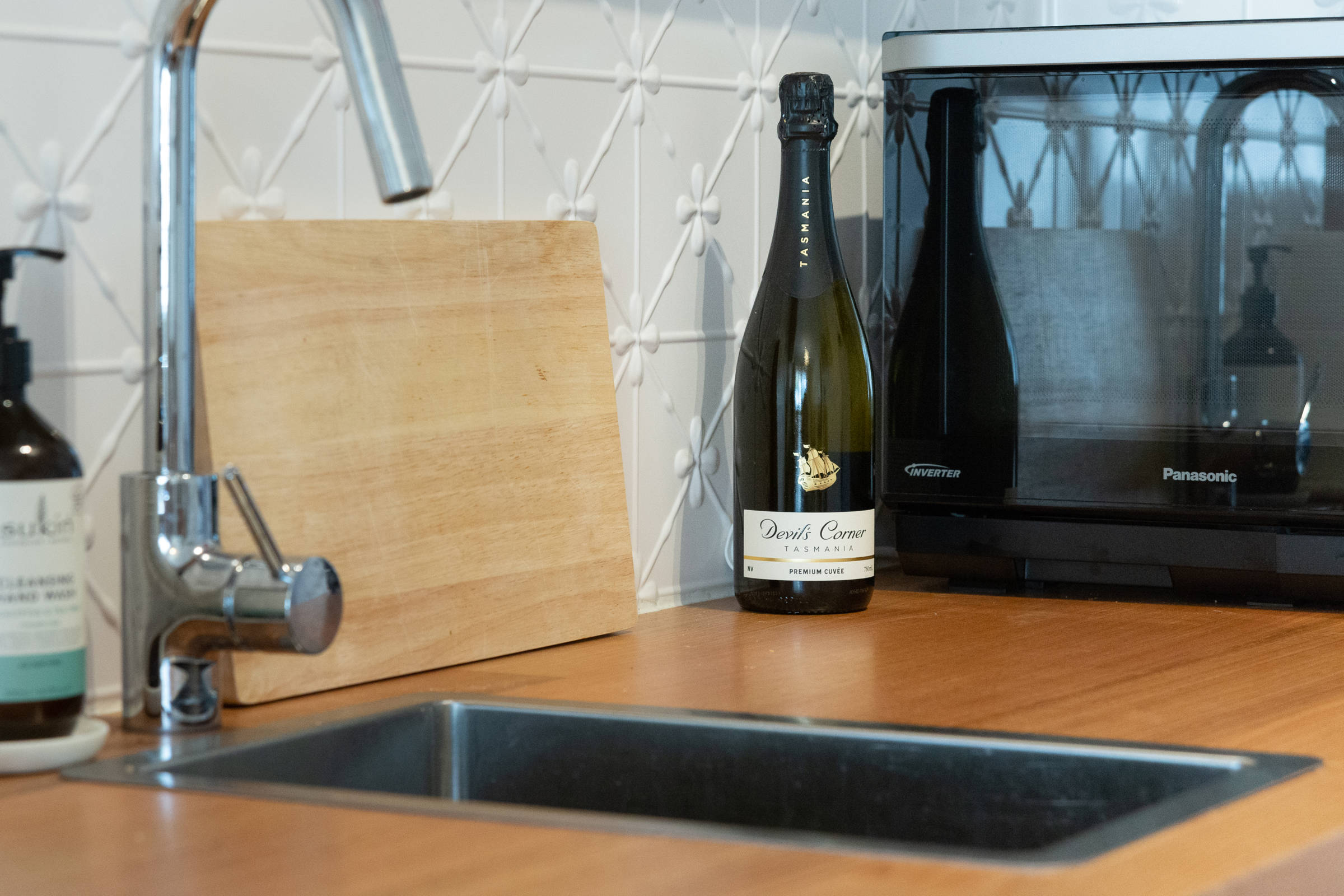 Close up of microwave and bottle of Tasmanian wine. Photo: Oliver Berlin.