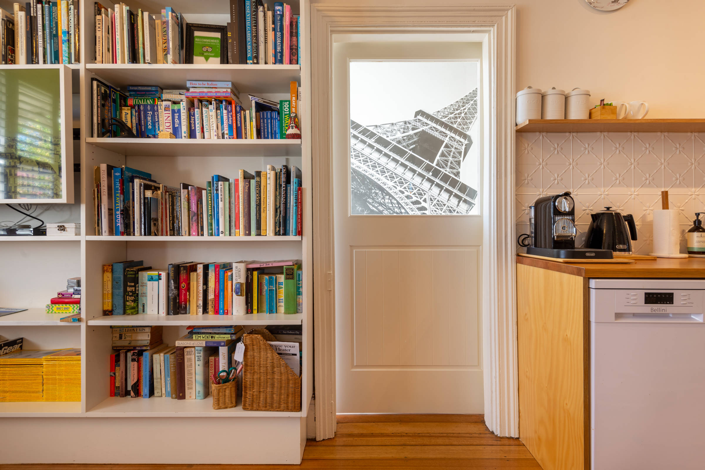 Bookshelves, doorway, kitchenette. Photo: Oliver Berlin.