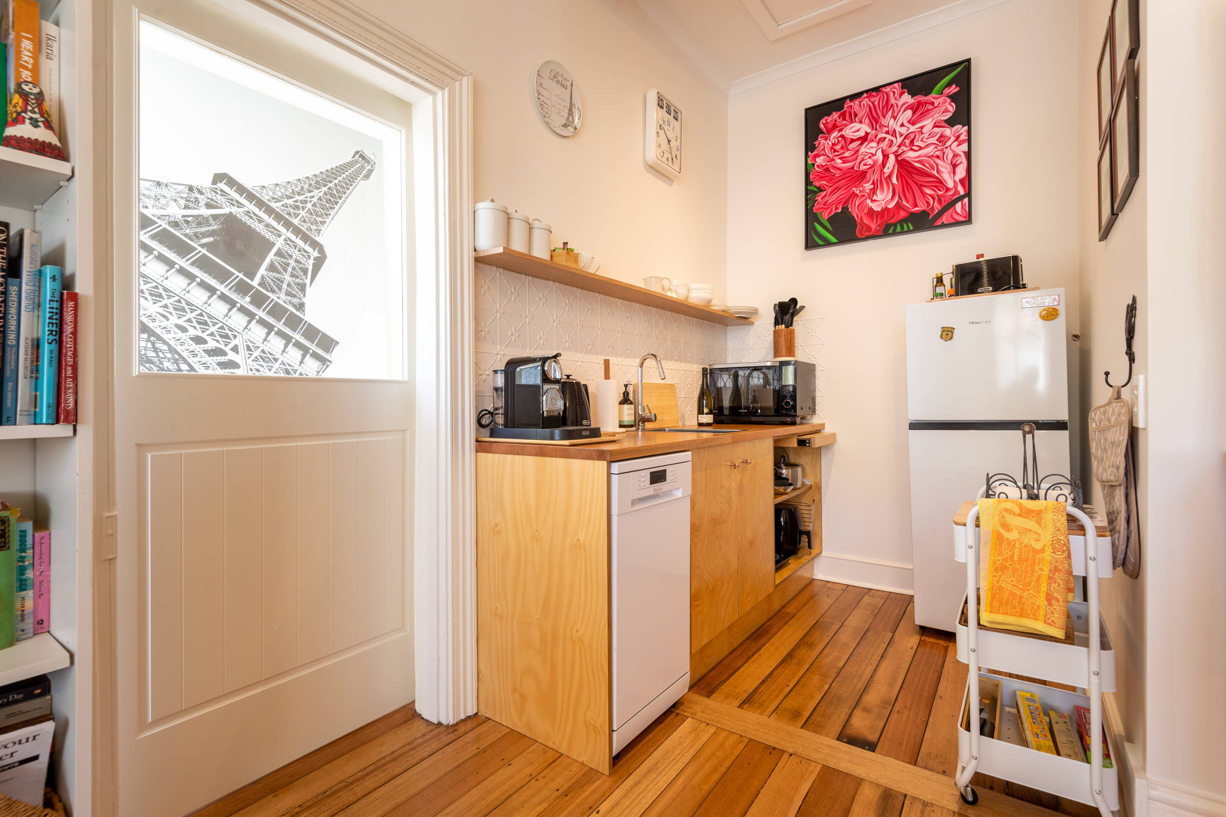 View of kitchenette, large pink painting on wall. Photo: Oliver Berlin.