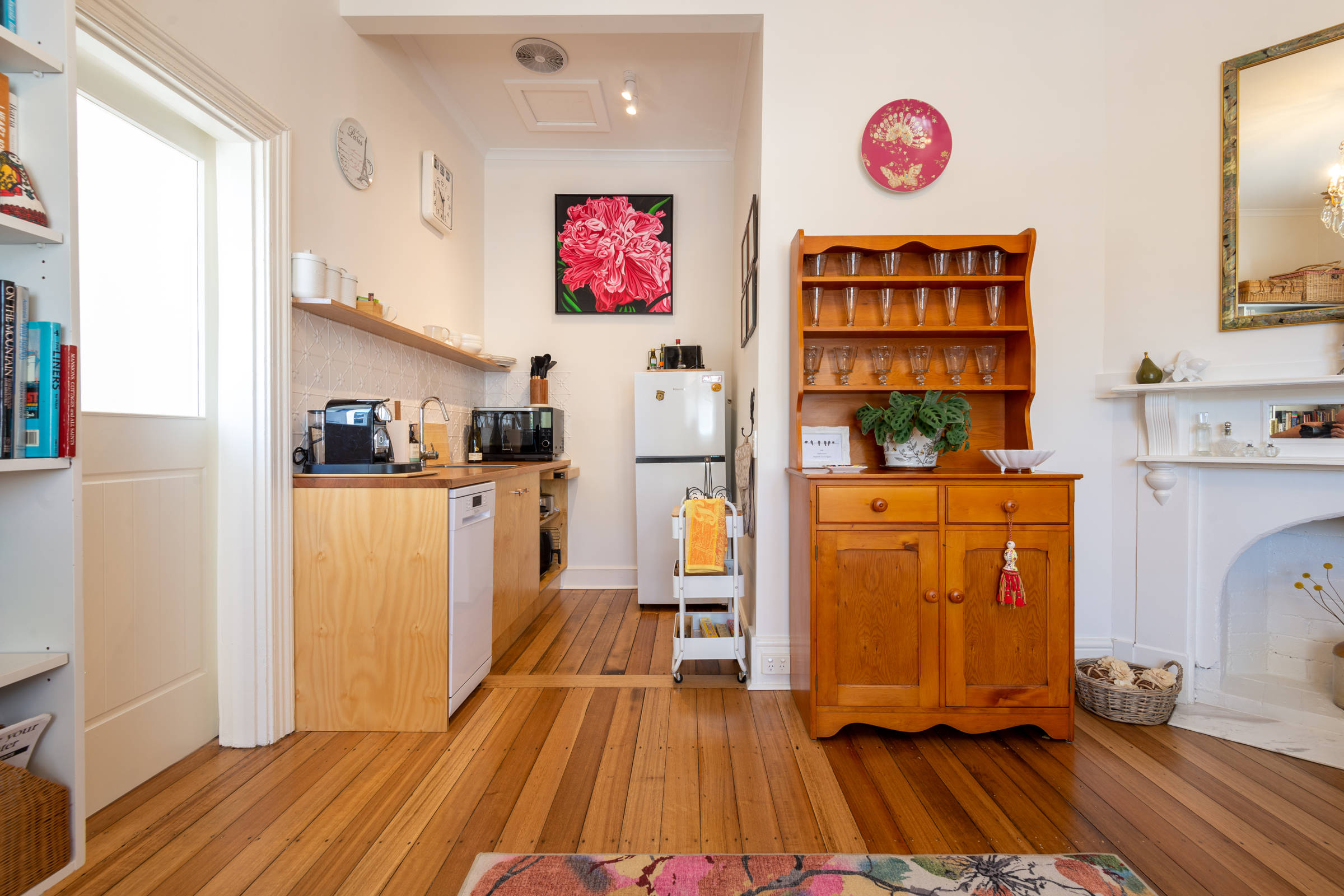 Kitchenette & kitchen dresser large pink painting on wall. Photo: Oliver Berlin.