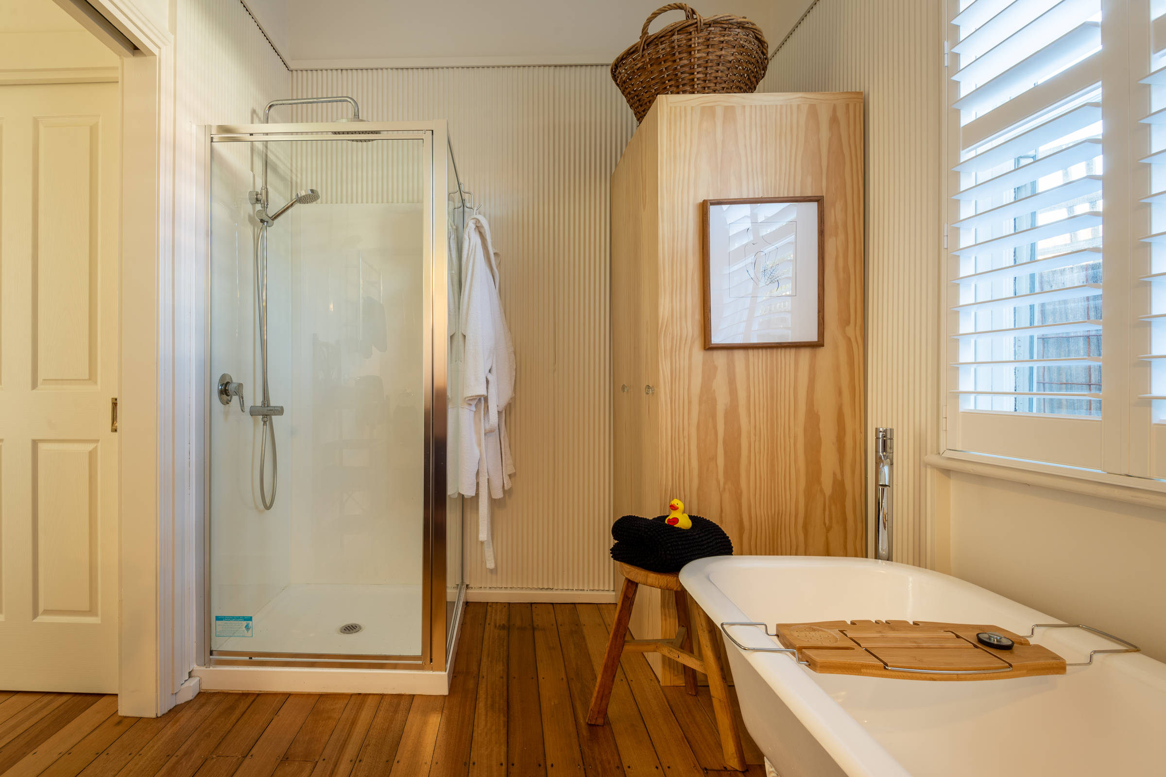 Bathroom showing shower, bath and cupboard. Photo: Oliver Berlin.