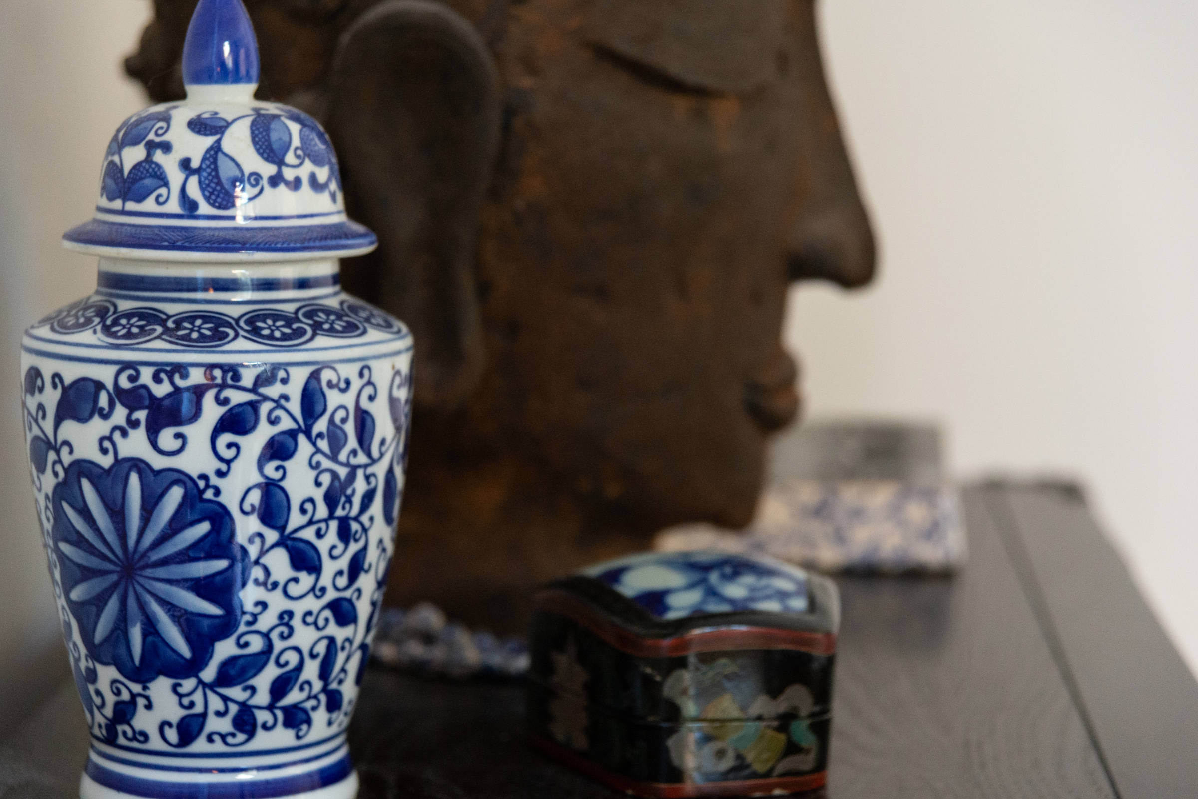 Close up of blue and white vase and statue. Photo: Oliver Berlin.