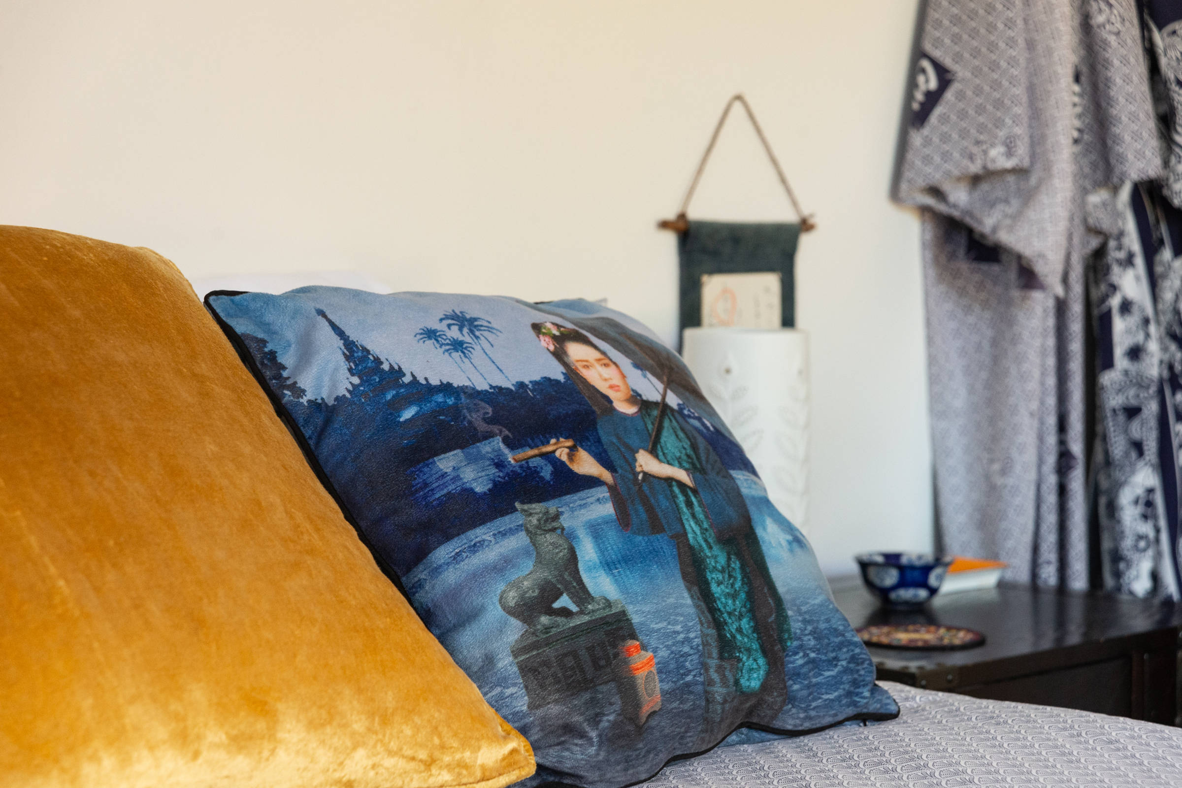 Close up of gold and  blue cushions on the bed. Photo: Oliver Berlin.